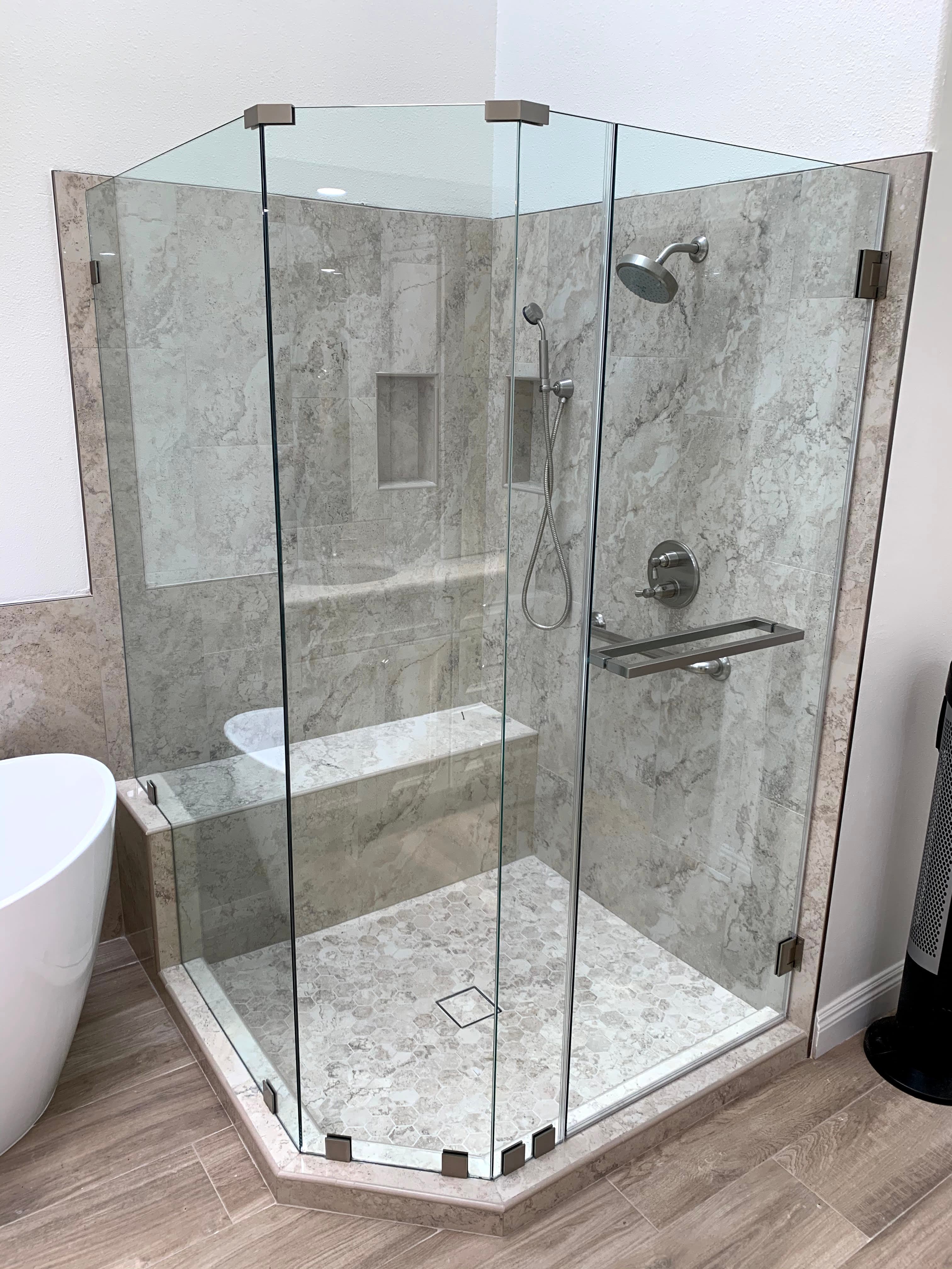 Frameless shower enclosure